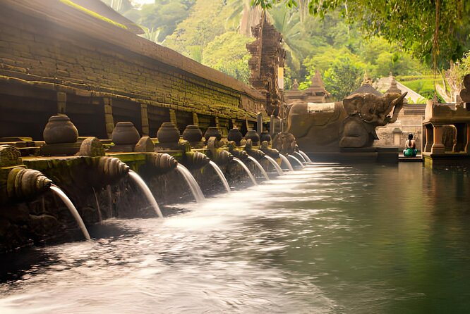 Ubud Bali: Rice Terrace, Waterfall and Tirta empul Day Tour - Kanto Lampo Waterfall, stone and spray