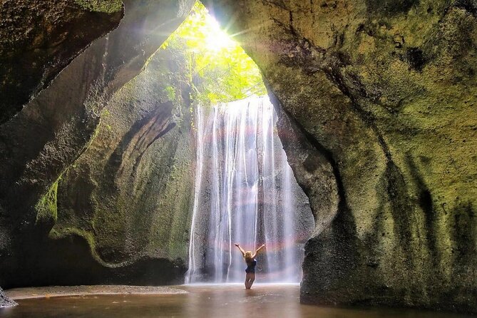 Ubud Waterfalls and Rice Terraces Private Day Tour - Kanto Lampo: water over dark rock